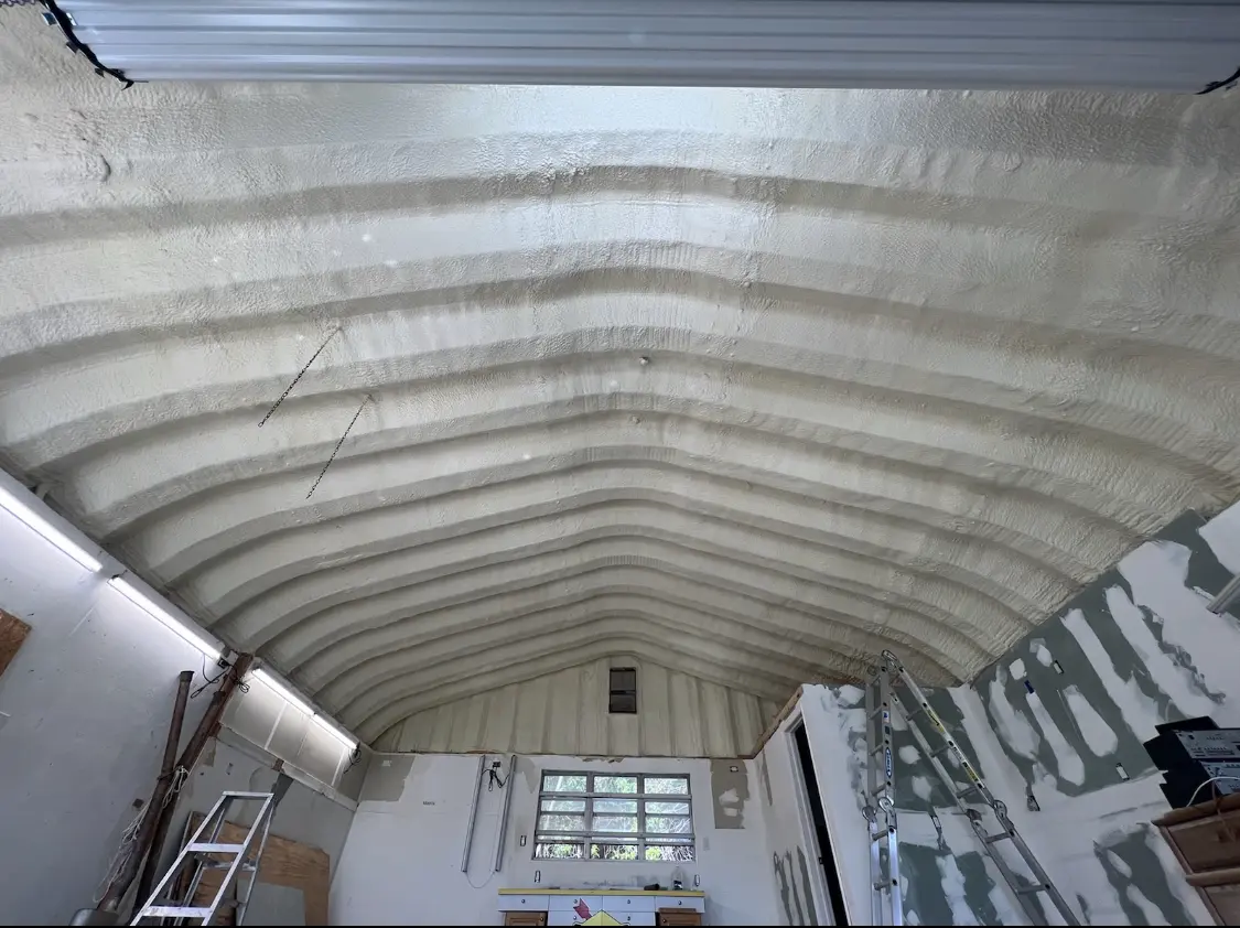 Spray polyurethane foam applied to the underside of a metal roof deck in Farmers Branch